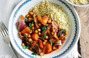 A bowl of food with couscous and meat.